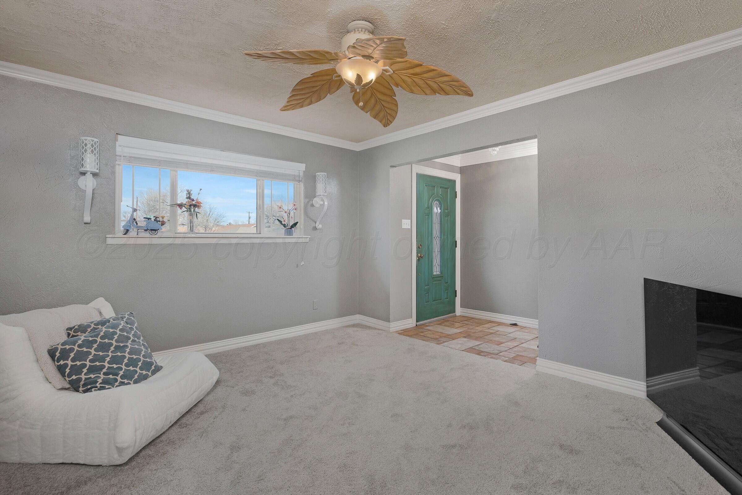 5211 Southwest 36th Avenue Amarillo, TX 79109 - Photo 2 of 22 a bedroom with a bed and a chandelier fan