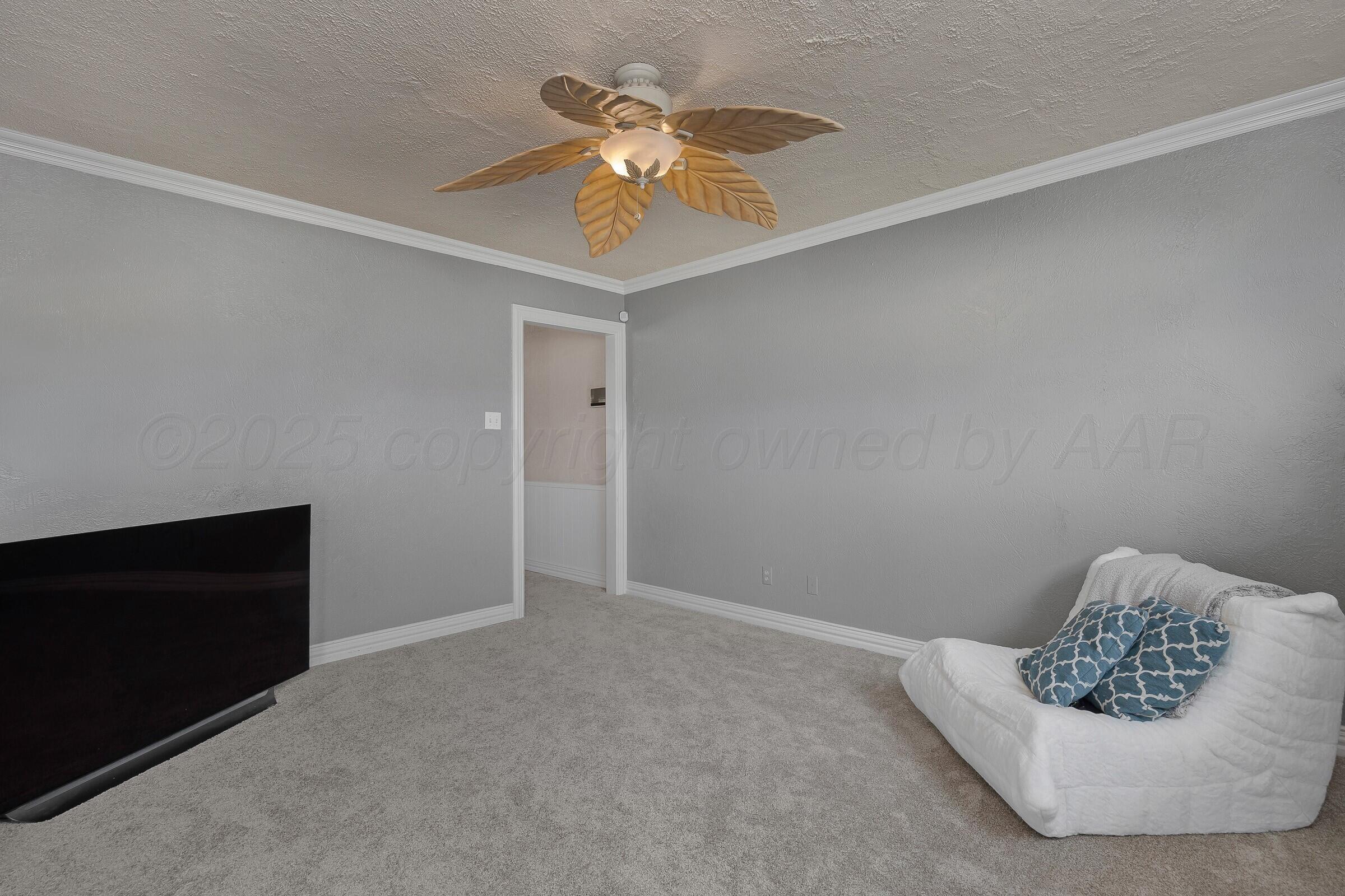 5211 Southwest 36th Avenue Amarillo, TX 79109 - Photo 4 of 22 a living room with furniture and a ceiling fan