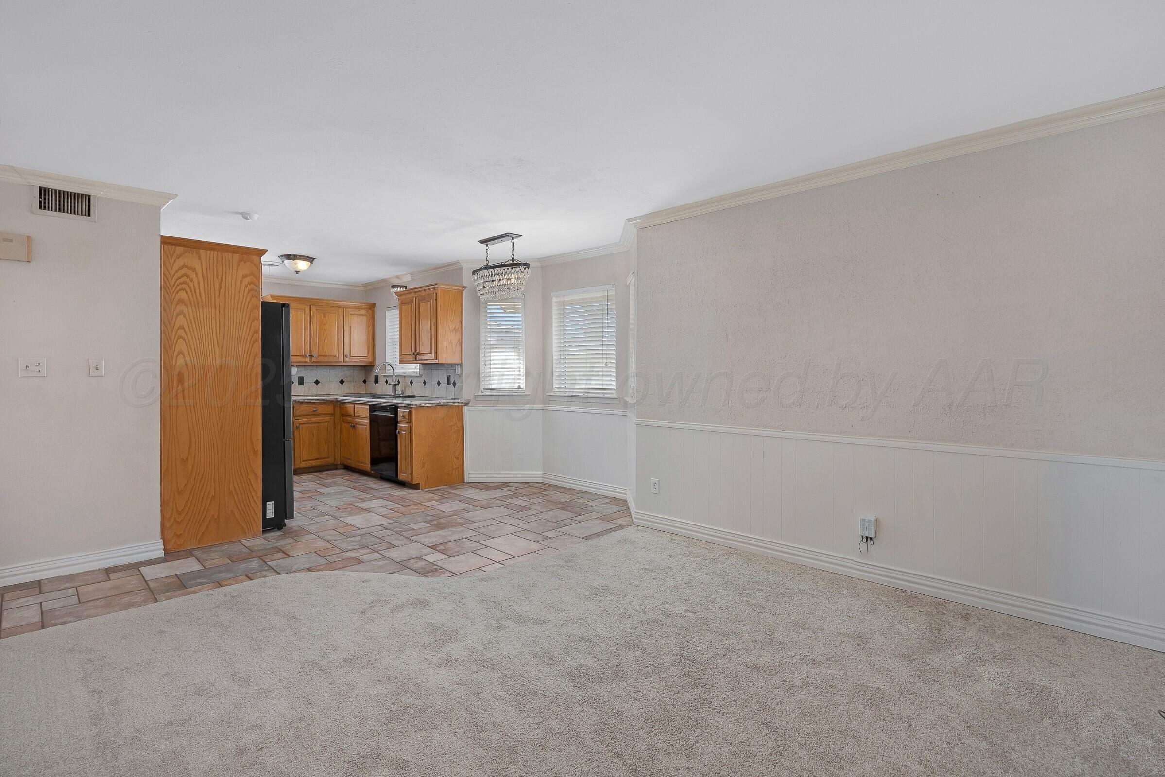 5211 Southwest 36th Avenue Amarillo, TX 79109 - Photo 5 of 22 a view of a kitchen with a sink and a refrigerator