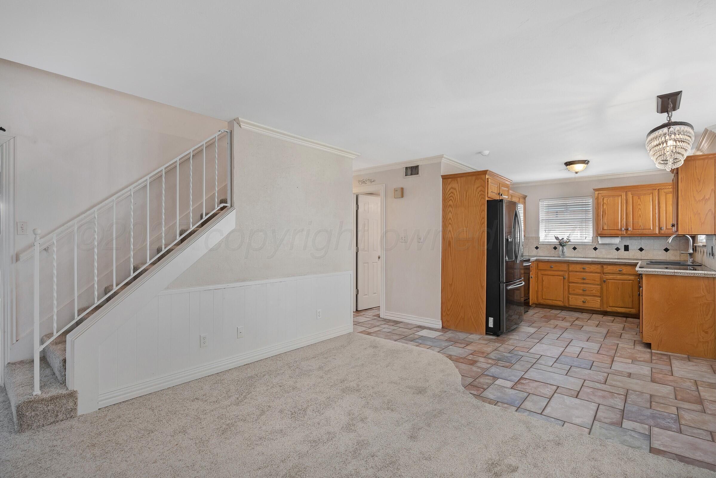 5211 Southwest 36th Avenue Amarillo, TX 79109 - Photo 7 of 22 a view of a kitchen with refrigerator and cabinets