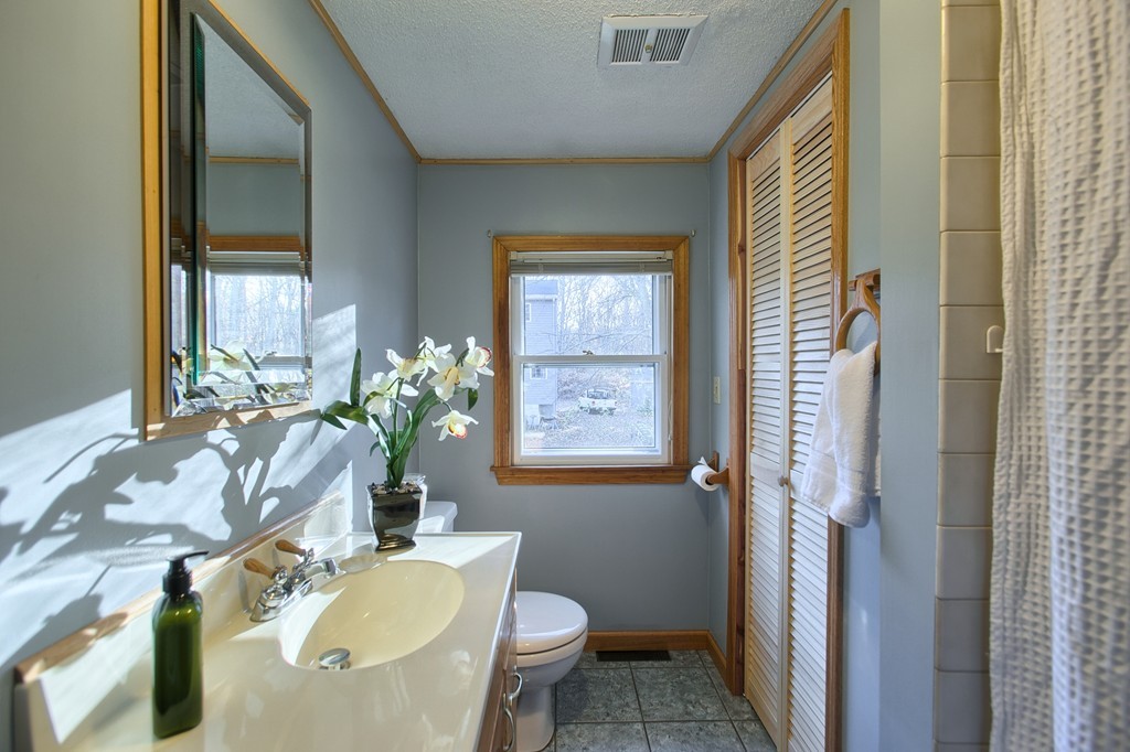 16 Loon Road Billerica, MA 01821 - Photo 12 of 24 a bath room with a sink and a mirror