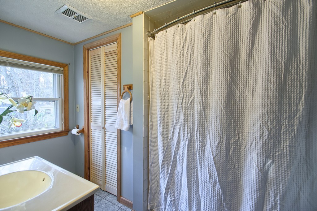 16 Loon Road Billerica, MA 01821 - Photo 13 of 24 a view of a room with a window and a bath tub