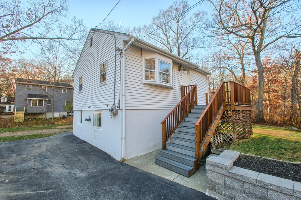 16 Loon Road Billerica, MA 01821 - Photo 15 of 24 a view of a white house next to a yard with big trees