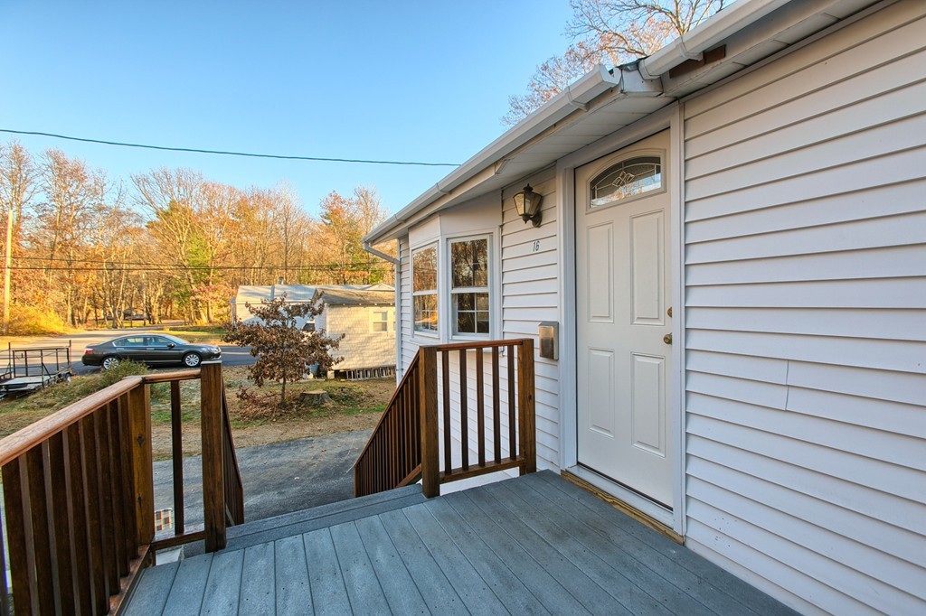 16 Loon Road Billerica, MA 01821 - Photo 17 of 24 a view of a porch with wooden floor and iron fence