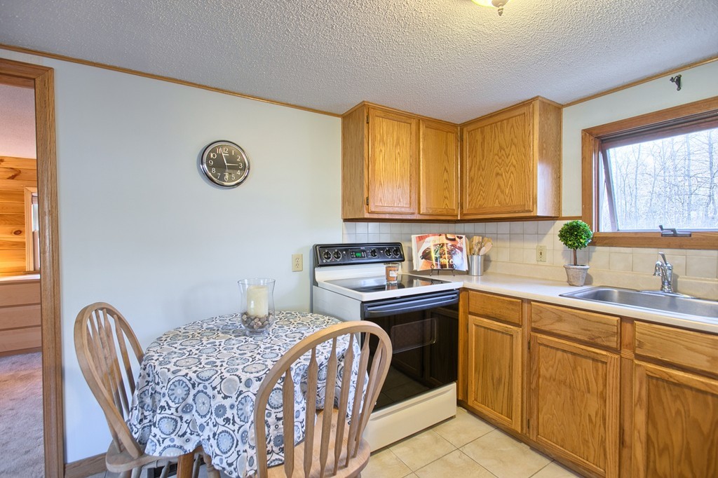 16 Loon Road Billerica, MA 01821 - Photo 5 of 24 a kitchen with a sink cabinets and window