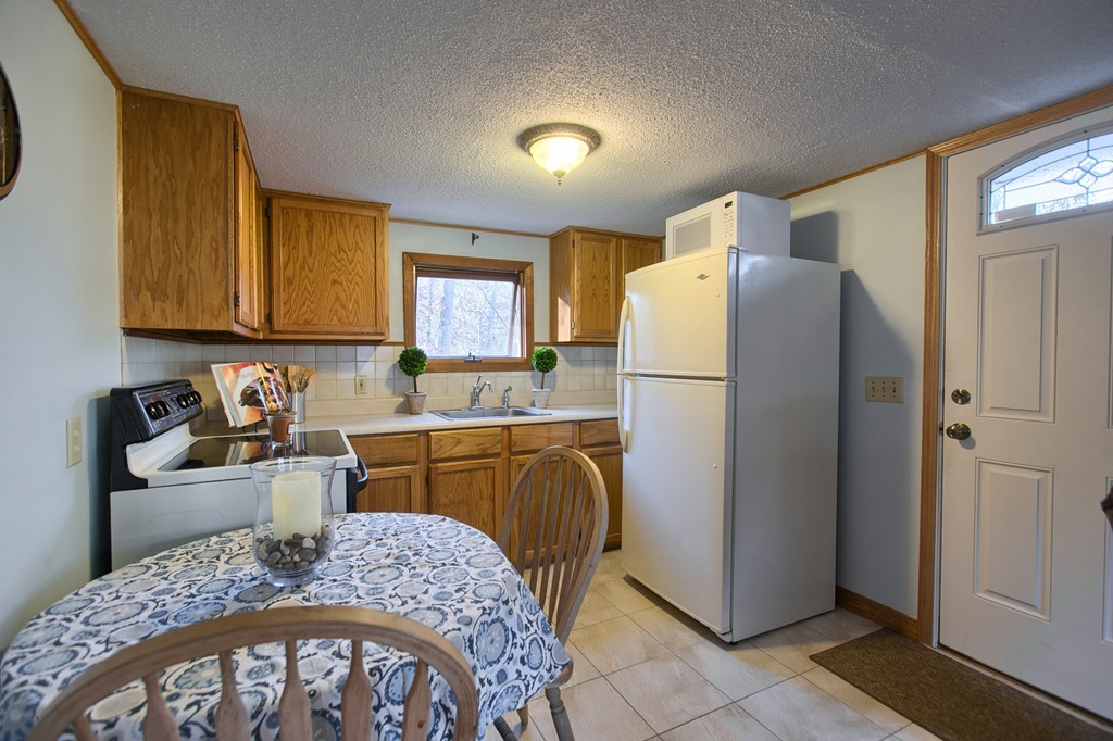 16 Loon Road Billerica, MA 01821 - Photo 6 of 24 a kitchen with stainless steel appliances granite countertop a refrigerator sink and stove