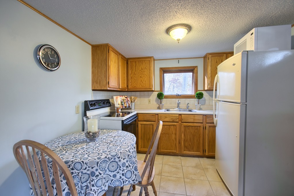 16 Loon Road Billerica, MA 01821 - Photo 7 of 24 a kitchen with stainless steel appliances granite countertop a sink and a refrigerator