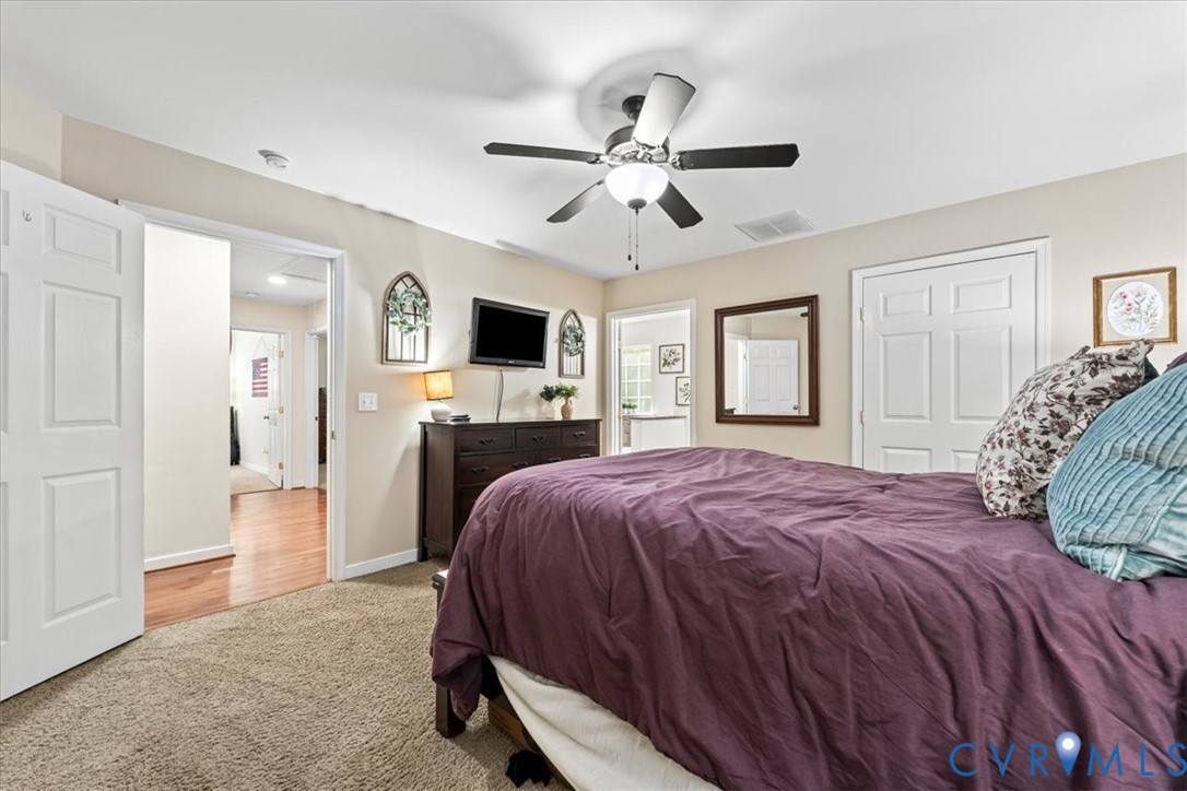 2043 Rocky Ford Road Powhatan, VA 23139 - Photo 21 of 78 a spacious bedroom with a bed and a flat screen tv