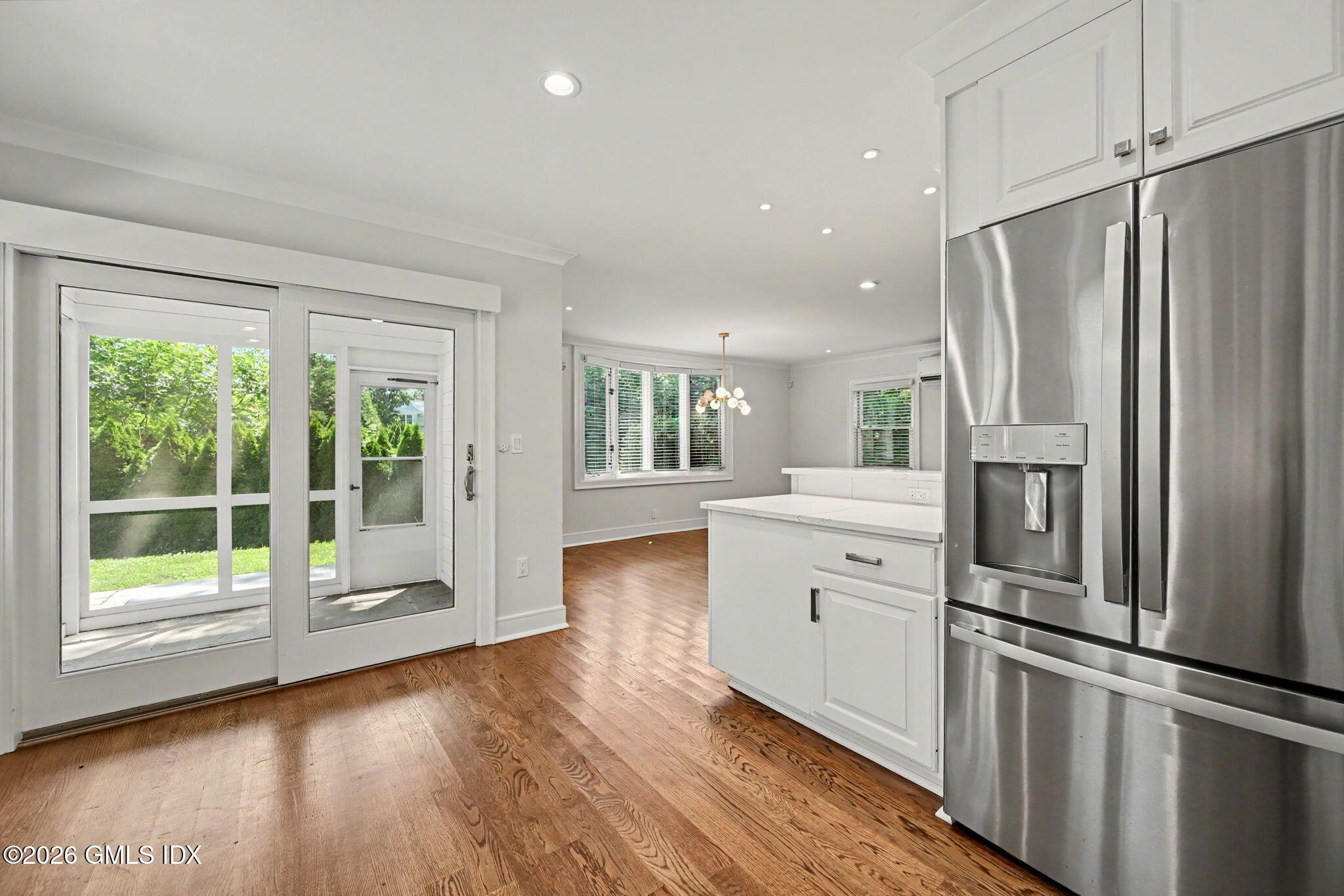 124 Shore Road Old Greenwich, CT 06870 - Photo 11 of 28 a kitchen with white cabinets and stainless steel appliances
