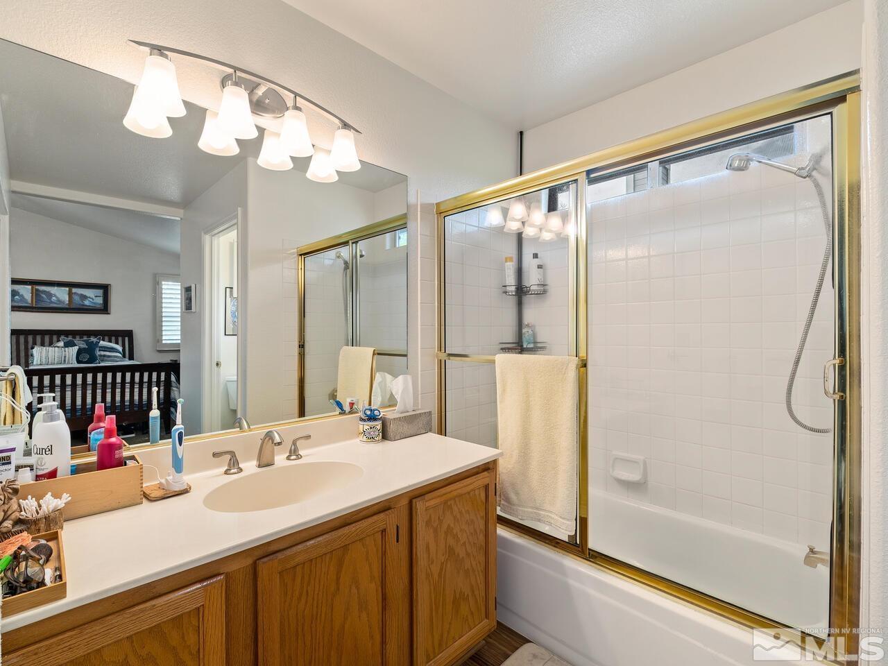 7593 Whimbleton Way Reno, NV 89511 - Photo 13 of 19 a bathroom with a sink double vanity and shower