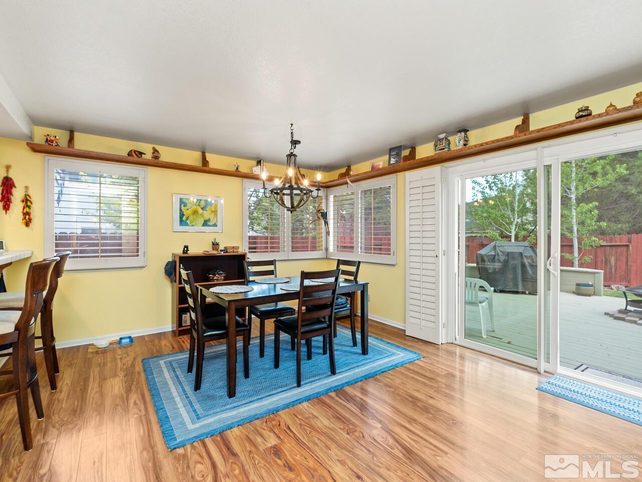 7593 Whimbleton Way Reno, NV 89511 - Photo 6 of 19 a view of a dining room with furniture and wooden floor