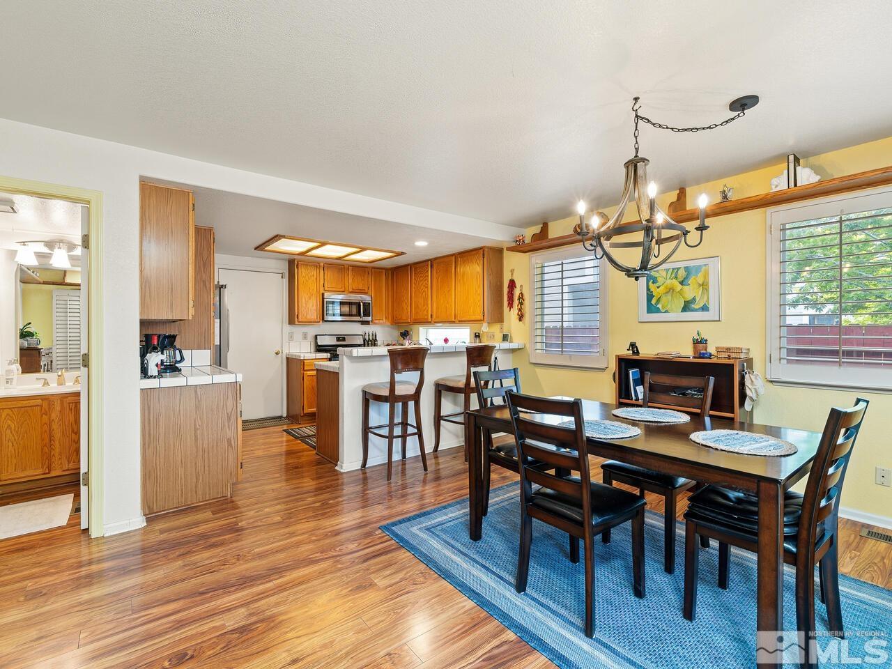 7593 Whimbleton Way Reno, NV 89511 - Photo 7 of 19 a view of a dining room with furniture and wooden floor