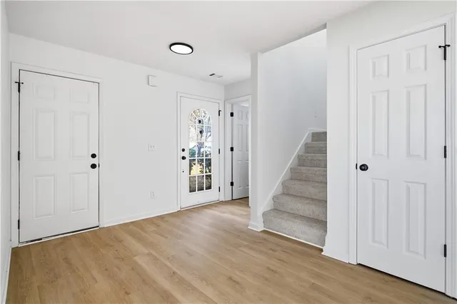 a view of entryway with stairs and wooden floor