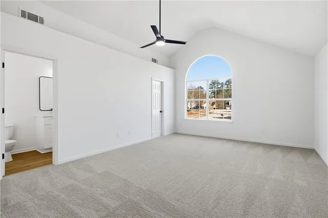 a view of a livingroom with a ceiling fan and window