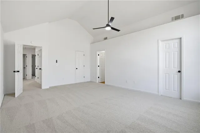 a view of empty room with ceiling fan