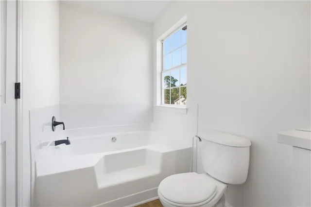 a bathroom with a toilet and a bathtub