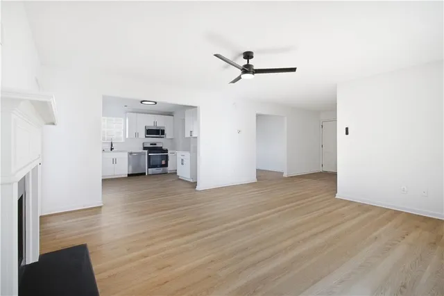 a view of a kitchen with a sink and a refrigerator