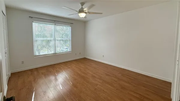 wooden floor in an empty room with a window
