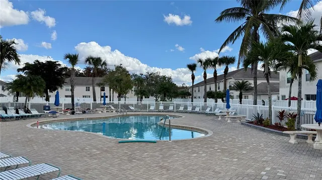 a view of a swimming pool with a table and chairs
