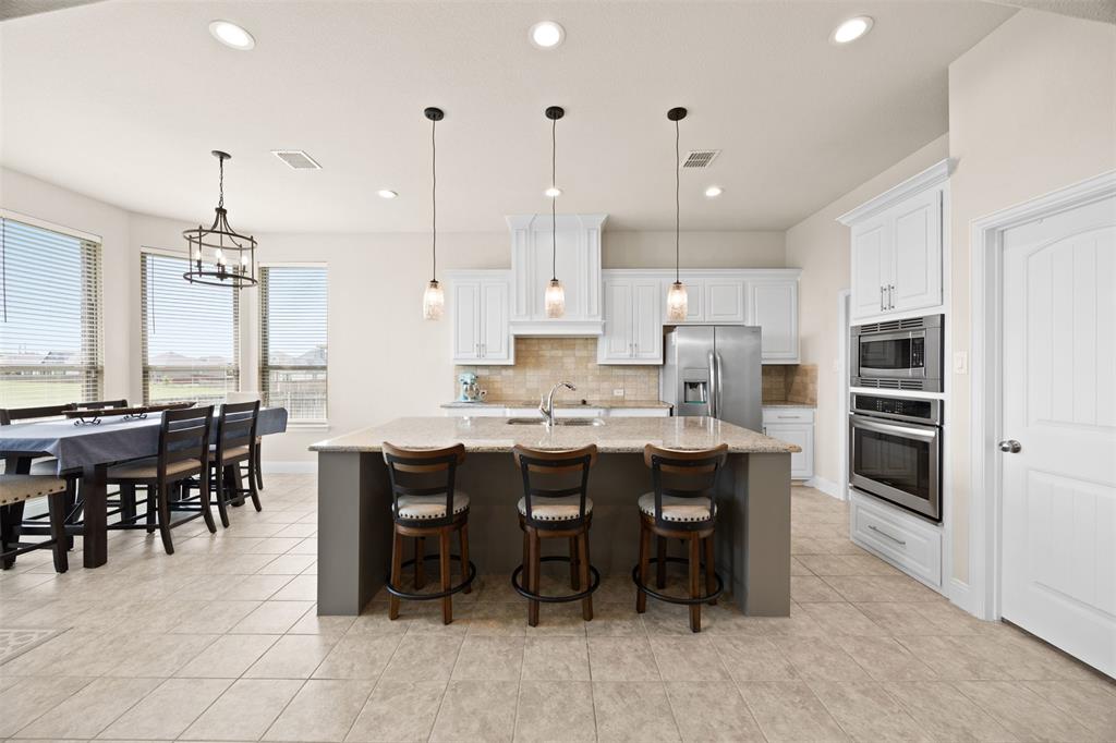 2618 Byrd Ranch Road Midlothian, TX 76065 - Photo 19 of 38 a large kitchen with a table and chairs