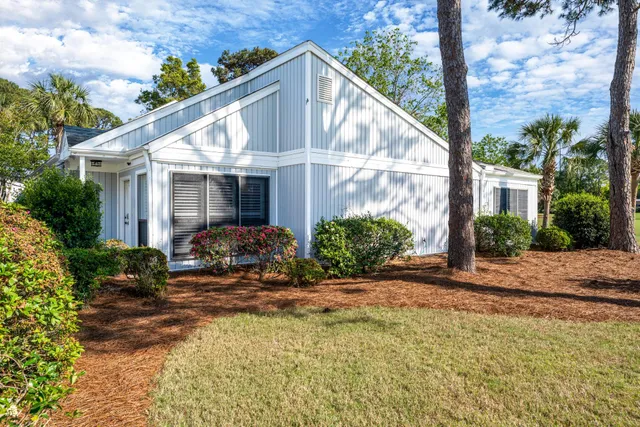 a view of a house with backyard and sitting area