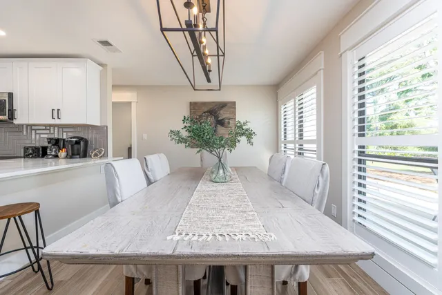 a view of a dining room with furniture window and wooden floor