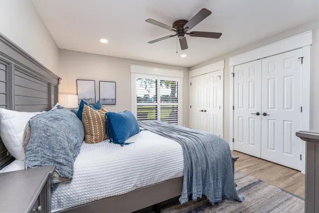 a bedroom with a large bed and a chandelier