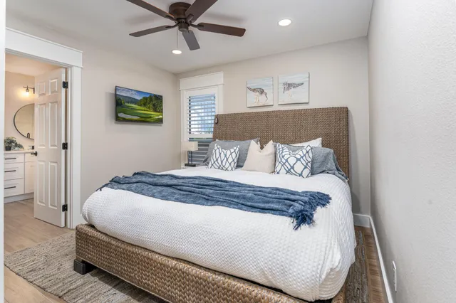 a bedroom with a bed and painting on the wall
