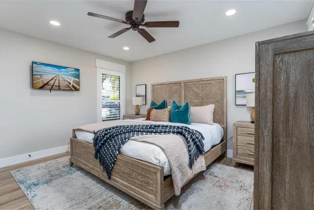 a spacious bedroom with a bed and a painting