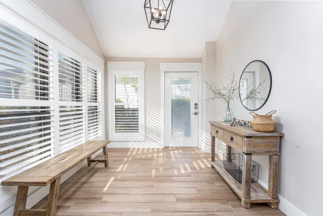 a view of a room with wooden floor and windows