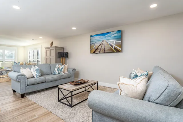 a living room with furniture and white walls