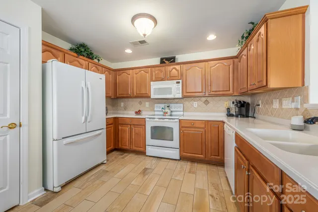 a kitchen with a refrigerator sink and cabinets