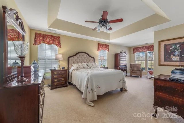 a bedroom with a bed couch and dresser