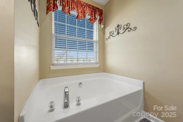 a bathroom with a bathtub and a window