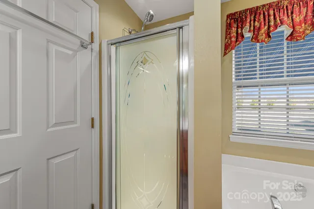 a bathroom with a shower and a mirror
