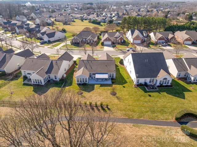an aerial view of a house with swimming pool and ocean view