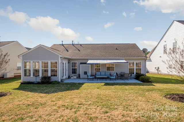 a view of a house with a yard and swimming pool