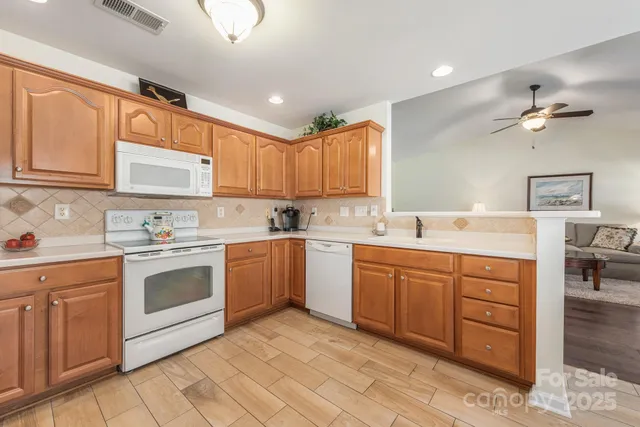 a kitchen with a sink cabinets and window