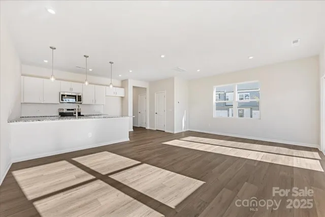 a view of kitchen with kitchen island sink and refrigerator
