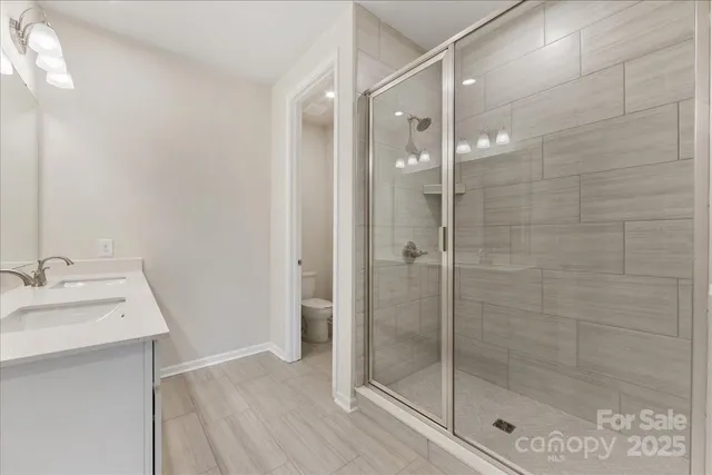 a bathroom with a shower and a sink