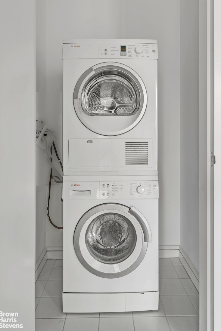 300 East 23rd Street, Unit 9B Manhattan, NY 10010 - Photo 10 of 14 a utility room with dryer and washer