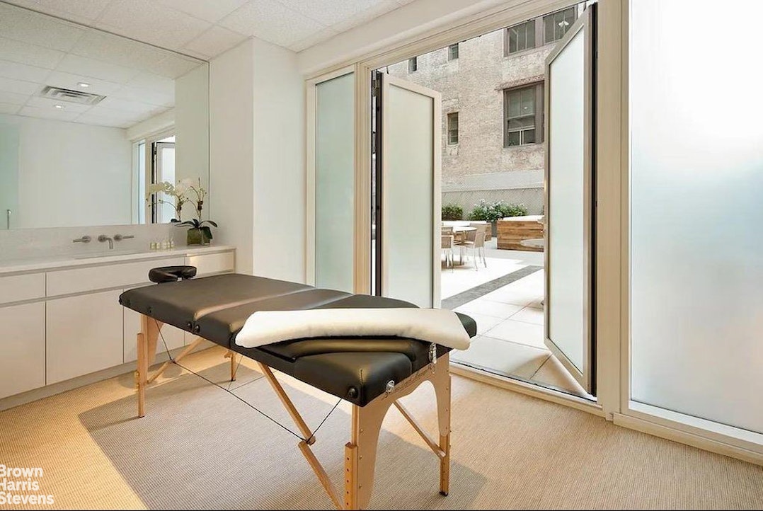 300 East 23rd Street, Unit 9B Manhattan, NY 10010 - Photo 13 of 14 a view of a dining room with furniture and a window
