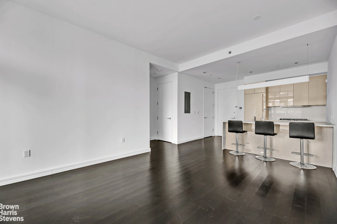 300 East 23rd Street, Unit 9B Manhattan, NY 10010 - Photo 4 of 14 a view of dining room with furniture and wooden floor