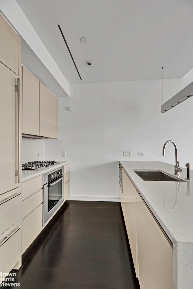 300 East 23rd Street, Unit 9B Manhattan, NY 10010 - Photo 5 of 14 a kitchen with a sink cabinets and appliances