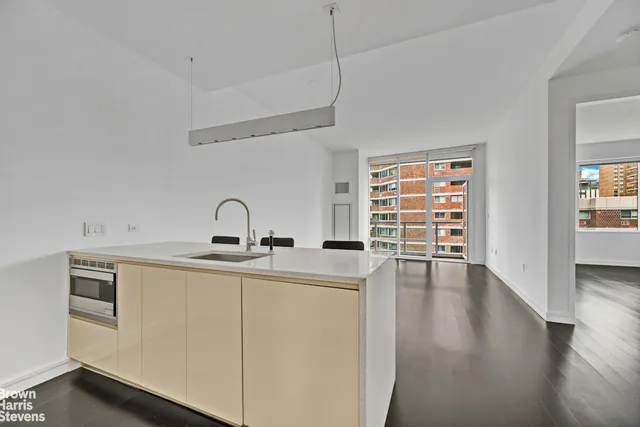 a kitchen with a sink cabinets and appliances