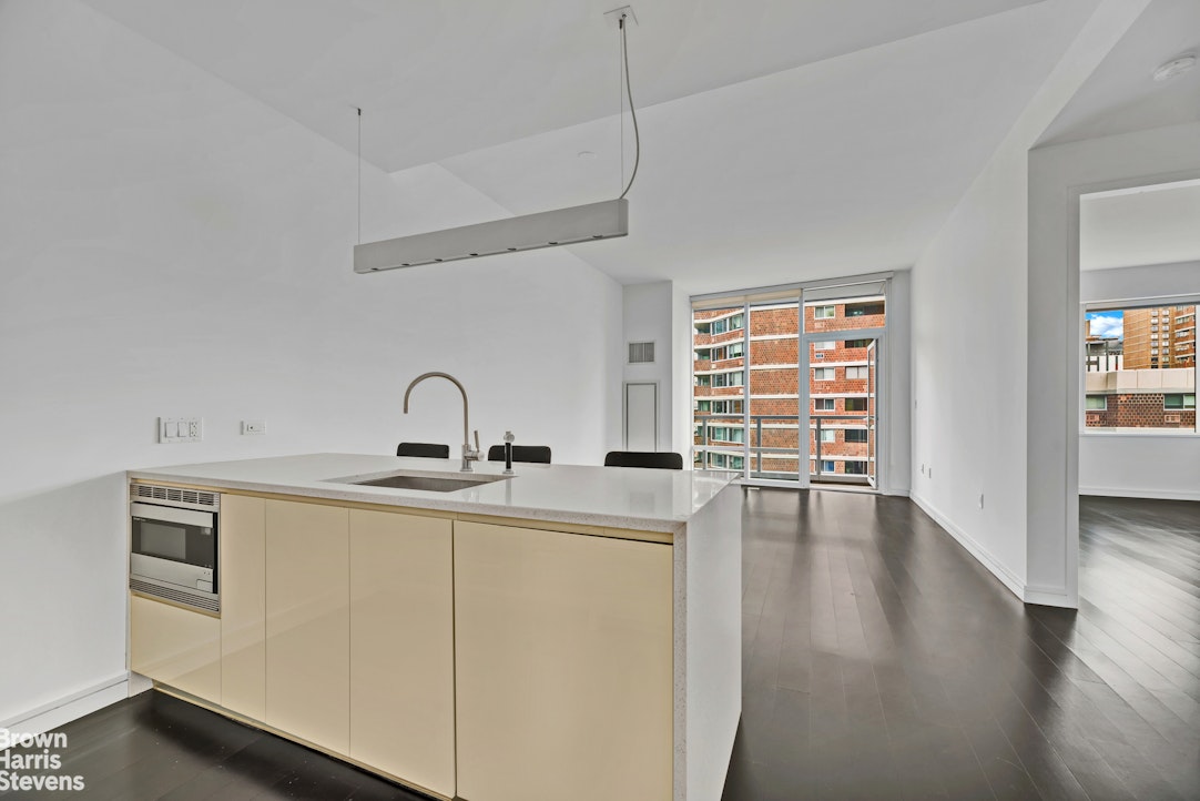 300 East 23rd Street, Unit 9B Manhattan, NY 10010 - Photo 6 of 14 a view of a kitchen with a sink dishwasher and a window