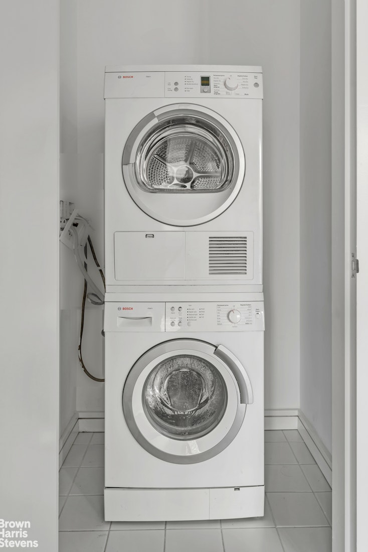 300 East 23rd Street, Unit 9B Manhattan, NY 10010 - Photo 8 of 14 a utility room with dryer and washer