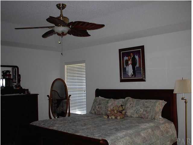 7477 Farmers Road Pensacola, FL 32526 - Photo 13 of 17 Owners Suite with Convenient Kitchen Access and Private Entry to Pool Area