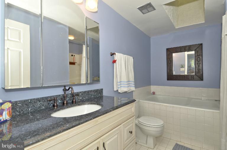 1544 Deer Point Way Reston, VA 20194 - Photo 9 of 27 a bathroom with a granite countertop sink and a mirror