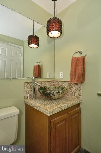 1544 Deer Point Way Reston, VA 20194 - Photo 10 of 27 a bathroom with a granite countertop sink a toilet and a mirror